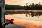 USA, New York. Adirondack Park, Saranac Lake, Hoel Pond, canoe at boathouse dock. Art Print